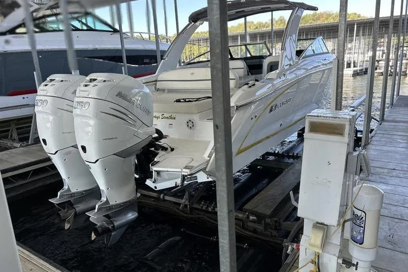 Slide: The Image of 2022 Cobalt 30SC Outboard boat with twin Mercury engines docked at marina. - 7
