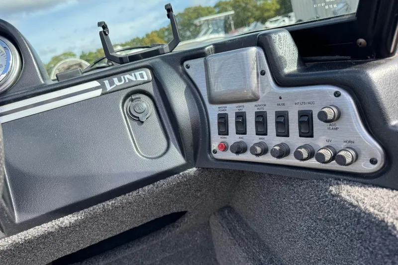 Slide: The Image of Control panel of 2020 Lund 1675 Adventure Sport boat with switches and dials. - 11