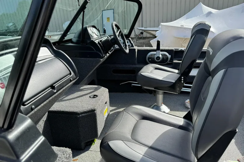 Slide: The Image of 2020 Lund 1675 Adventure Sport boat interior with steering wheel and seating. - 12