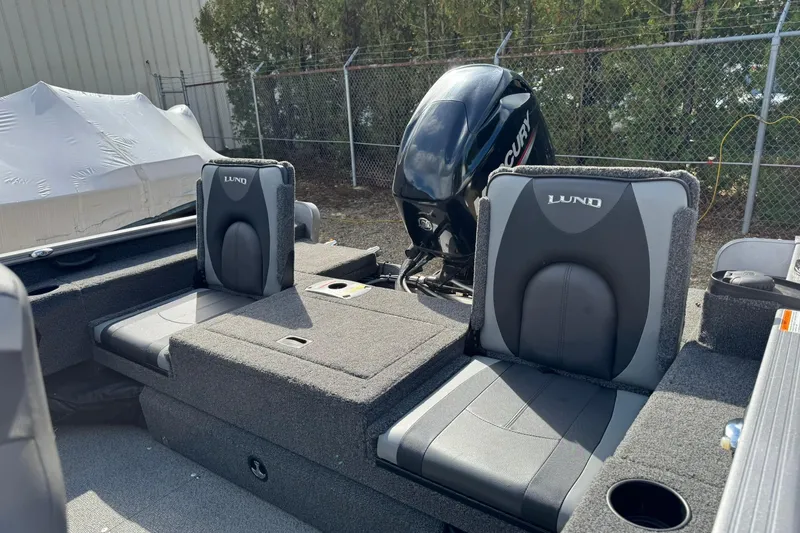 Slide: The Image of 2020 Lund 1675 Adventure Sport boat interior with Mercury engine, featuring comfortable seating. - 17