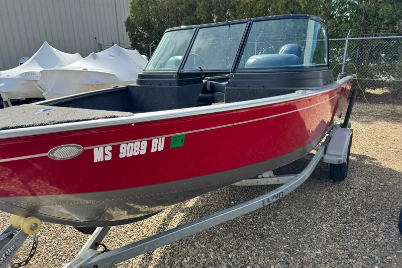 Slide: The Image of Red 2020 Lund 1675 Adventure Sport boat on trailer, parked outdoors. - 5