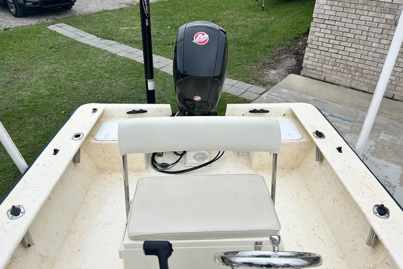 Slide: The Image of Jones Brothers 22 Bateau 2000 boat interior with motor, parked on grass. - 13