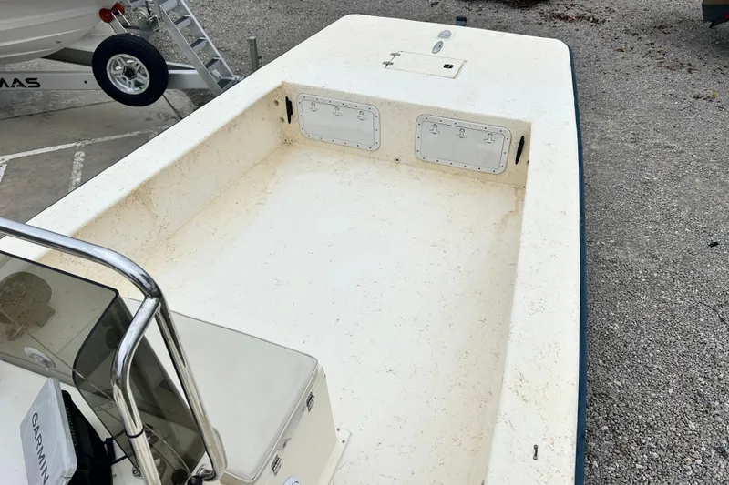 Slide: The Image of 2000 Jones Brothers 22 Bateau boat interior with open deck and storage compartments. - 19