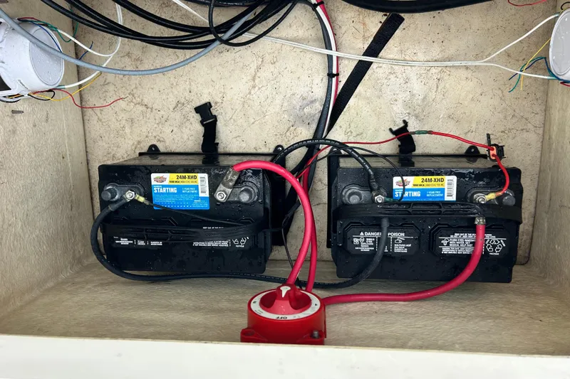 Slide: The Image of Two marine batteries in a 2000 Jones Brothers 22 Bateau boat compartment. - 21