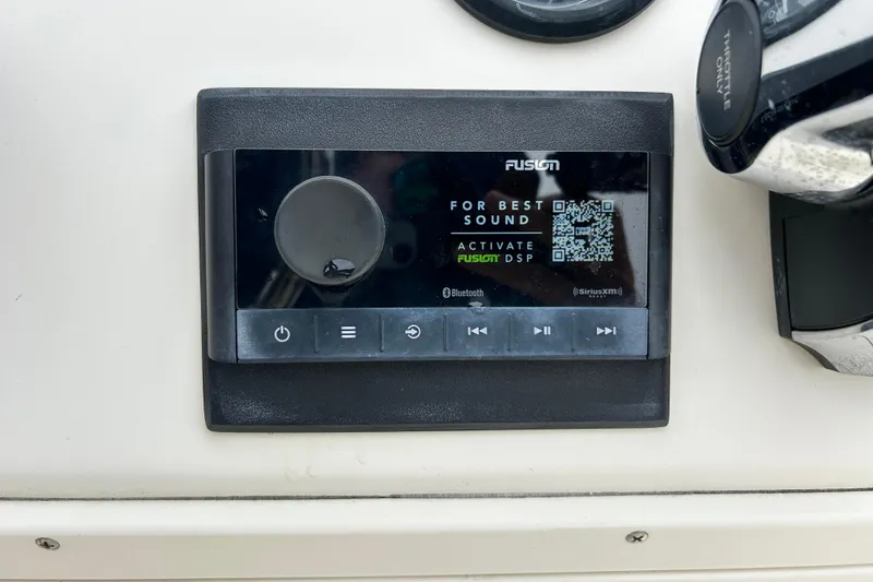 Slide: The Image of Fusion audio control panel on 2000 Jones Brothers 22 Bateau boat dashboard. - 24