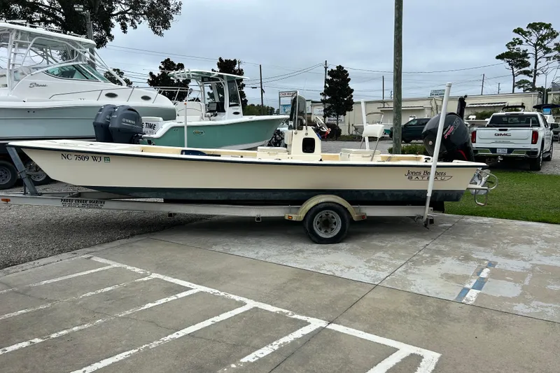 Slide: The Image of 2000 Jones Brothers 22 Bateau boat on trailer in marina parking lot. - 3