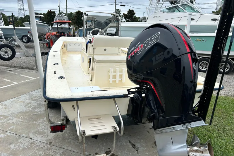 Slide: The Image of Jones Brothers 22 Bateau 2000 boat with Mercury Pro XS 150 engine at a marina. - 5