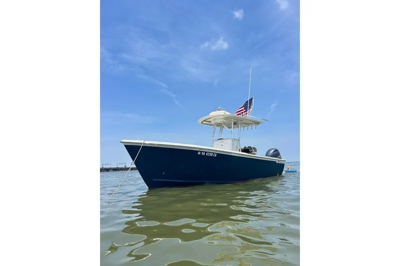 The Image of Custom Dominion 23 boat on water at sunset, with Yamaha engine, 2023 model. - 0