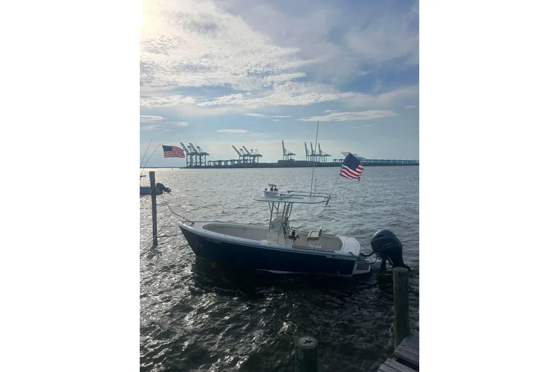 Slide: The Image of Custom Dominion 23 boat, 2023 model, with Yamaha outboard motor on a trailer. - 17