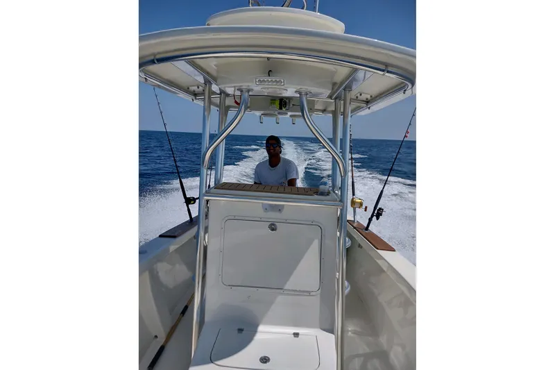 Slide: The Image of Man steering Custom Dominion 23 boat on open sea, 2023 model. - 19