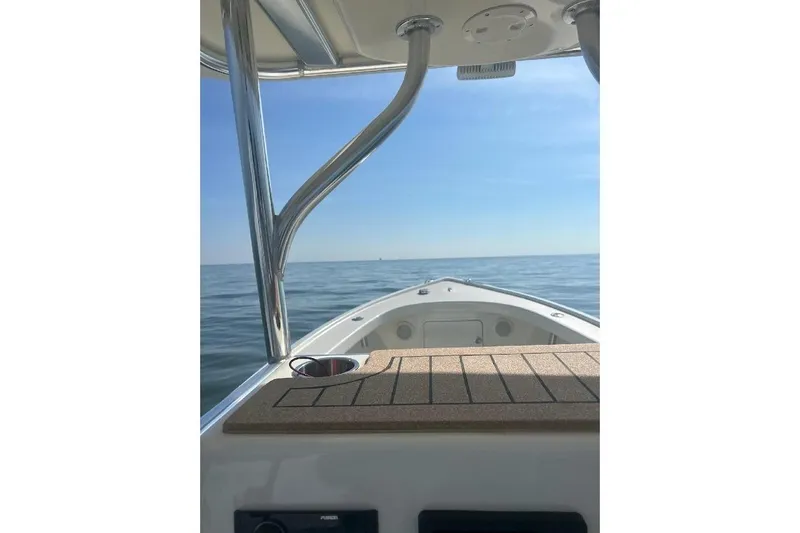 Slide: The Image of Custom Dominion 23 boat on calm sea, clear sky, 2023 model. - 21