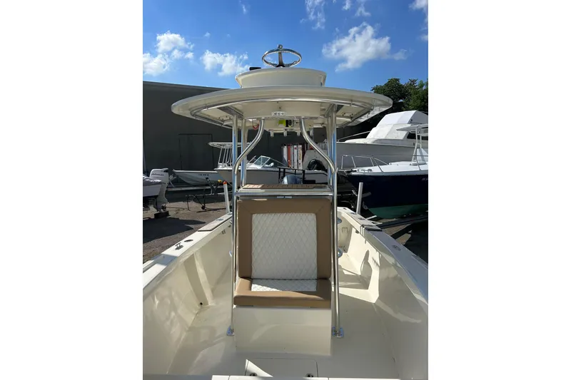 Slide: The Image of Custom Dominion 23 boat, 2023 model, docked with fishing equipment and seating area. - 4