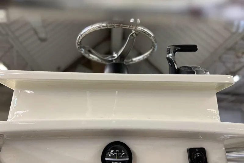 Slide: The Image of Custom Dominion 23 boat, 2023 model, featuring a center console and T-top under a clear sky. - 5