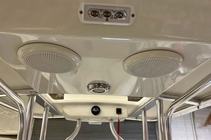 Slide: The Image of Control panel of 2023 Custom Dominion 23 boat with steering wheel and navigation equipment. - 7