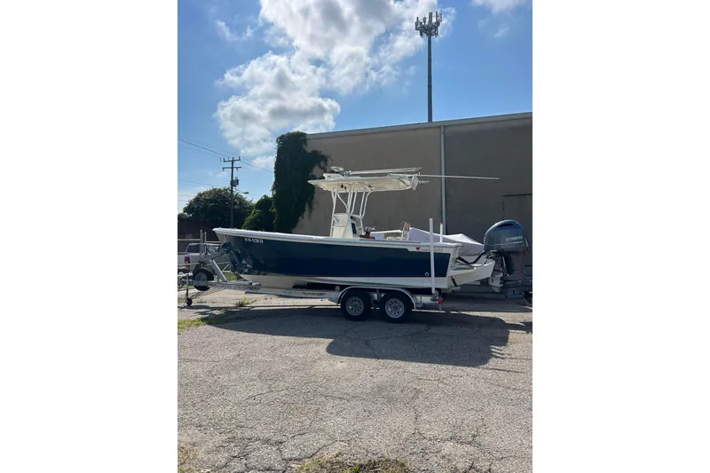 Slide: The Image of Custom Dominion 23 boat, 2023 model, on trailer with Yamaha outboard motor. - 9