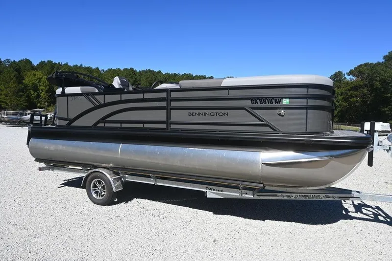 The Image of 2025 Bennington S 20 SSR pontoon boat on trailer, parked on gravel lot. - 1