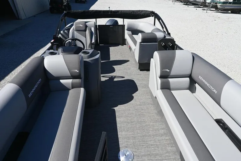 Slide: The Image of 2025 Bennington S 20 SSR pontoon boat interior with gray seating and steering console. - 13