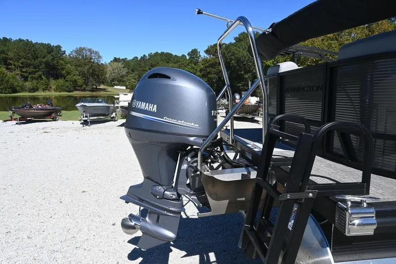 Slide: The Image of 2025 Bennington S 20 SSR pontoon boat with Yamaha outboard motor, parked near a lake. - 3