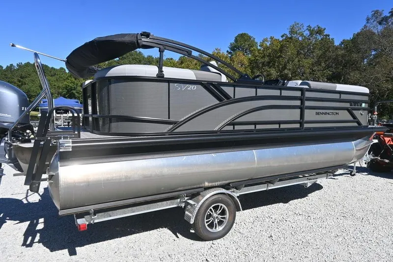 Slide: The Image of 2025 Bennington S 20 SSR pontoon boat on trailer, parked outdoors. - 5