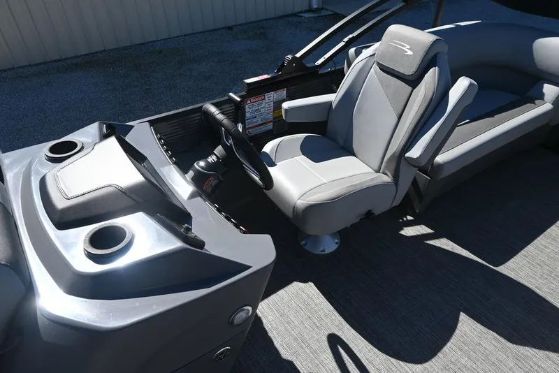 Slide: The Image of 2025 Bennington S 20 SSR boat interior with gray captain's chair and dashboard. - 8