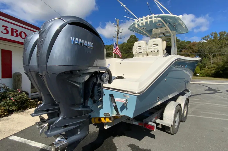 Slide: The Image of 2021 Cobia 280 Center Console boat with dual Yamaha engines on a trailer. - 10