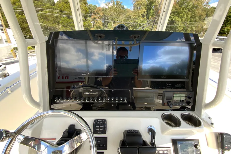 Slide: The Image of 2021 Cobia 280 Center Console dashboard with dual Garmin displays and controls. - 13