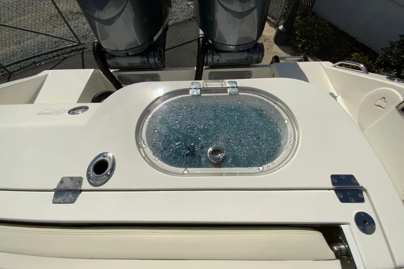 Slide: The Image of 2021 Cobia 280 Center Console boat with livewell and dual outboard motors. - 18