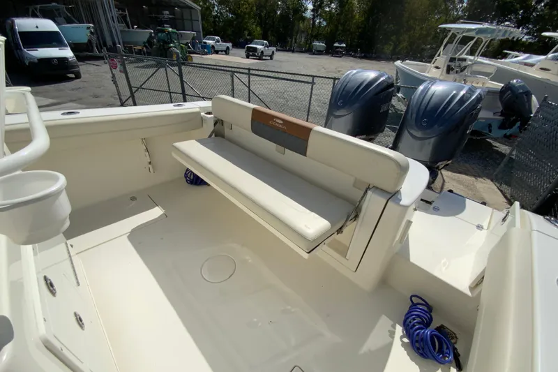 Slide: The Image of 2021 Cobia 280 Center Console boat with foldable seating and dual outboard engines. - 20