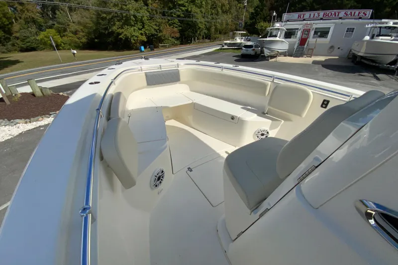 Slide: The Image of 2021 Cobia 280 Center Console boat interior at dealership, featuring spacious seating and modern design. - 21