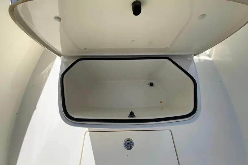 Slide: The Image of Open storage compartment on a 2021 Cobia 280 Center Console boat. - 26