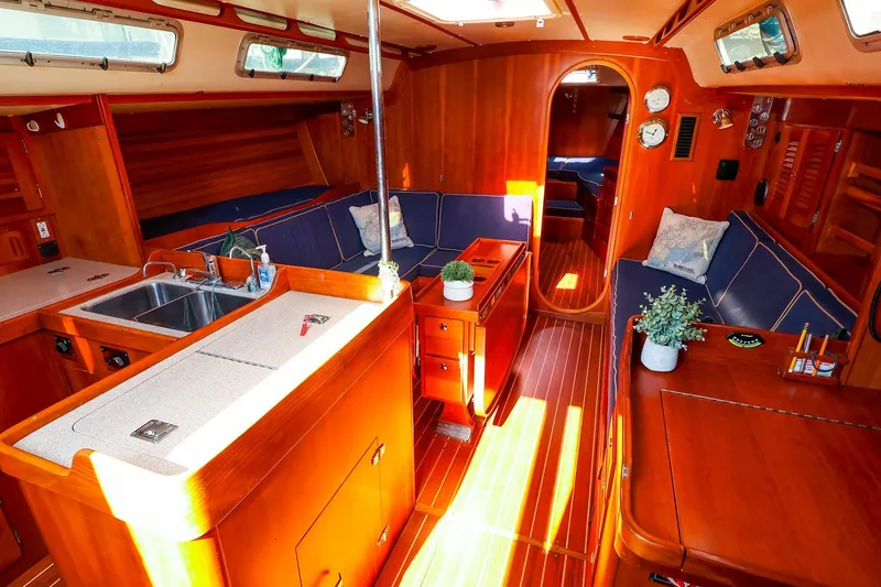 Slide: The Image of Luxurious 2002 J Boats J/46 yacht interior with wood finish and cozy seating area. - 18