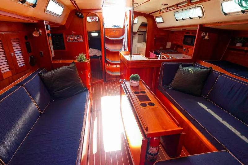 Slide: The Image of Luxurious 2002 J Boats J/46 yacht interior with elegant wood finish and cozy seating. - 19