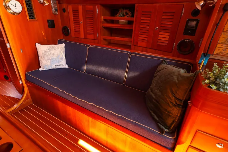 Slide: The Image of Luxurious interior of 2002 J Boats J/46 with blue cushioned seating and wooden cabinetry. - 22