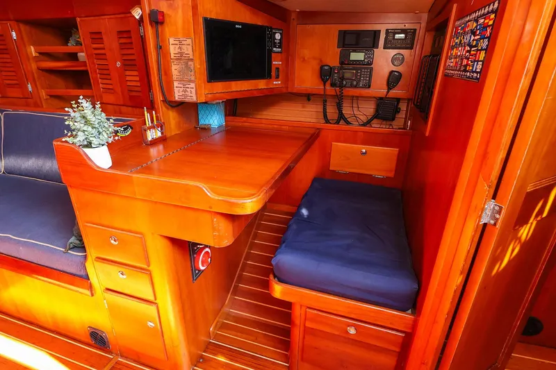 Slide: The Image of Interior of 2002 J Boats J/46 sailboat with navigation station and wooden cabinetry. - 23