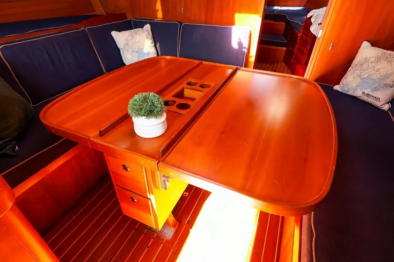 Slide: The Image of Luxurious interior of 2002 J Boats J/46 yacht with wooden table and cozy seating. - 24