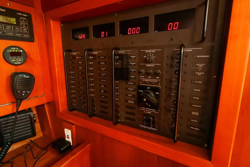 Slide: The Image of Electrical control panel on a 2002 J Boats J/46 yacht, featuring various switches and displays. - 26