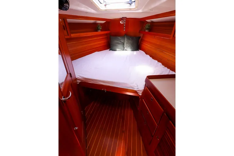 Slide: The Image of Luxurious cabin interior of 2002 J Boats J/46 with wooden finish and cozy bedding. - 30