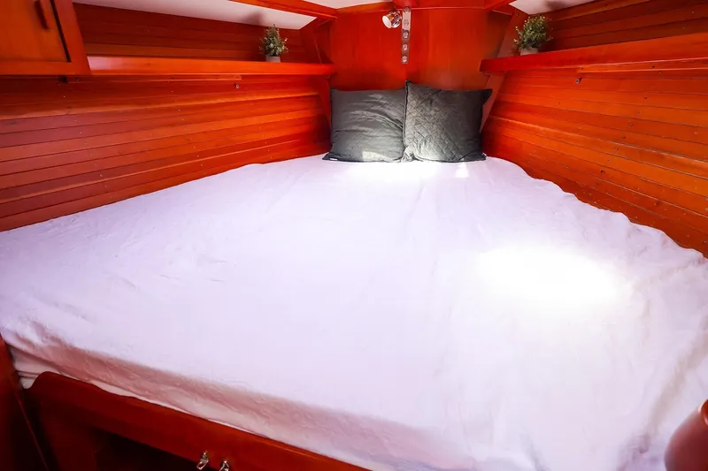 Slide: The Image of Cozy cabin interior of 2002 J Boats J/46 with wooden paneling and comfortable bedding. - 31