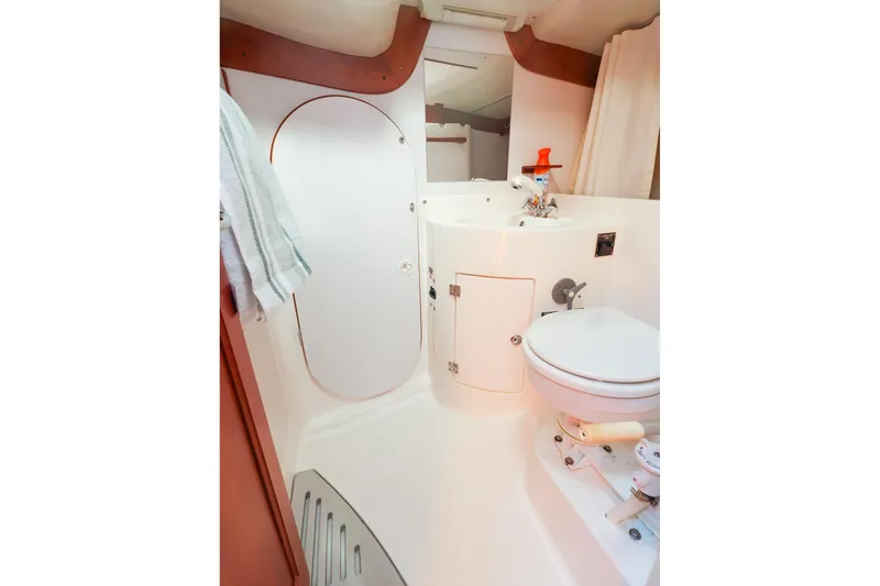 Slide: The Image of 2002 J Boats J/46 yacht bathroom with white fixtures and compact design. - 33