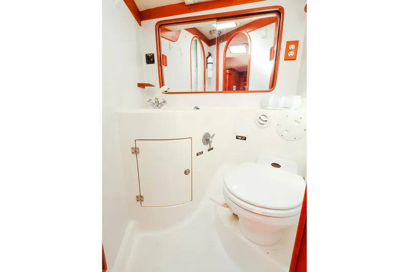 Slide: The Image of 2002 J Boats J/46 yacht bathroom with white fixtures and wooden accents. - 34