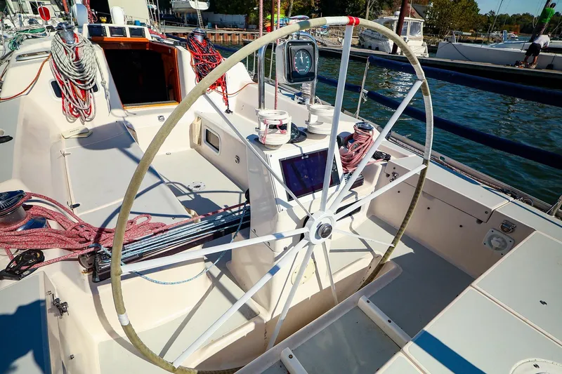 Slide: The Image of 2002 J Boats J/46 sailboat cockpit with steering wheel and nautical equipment. - 6