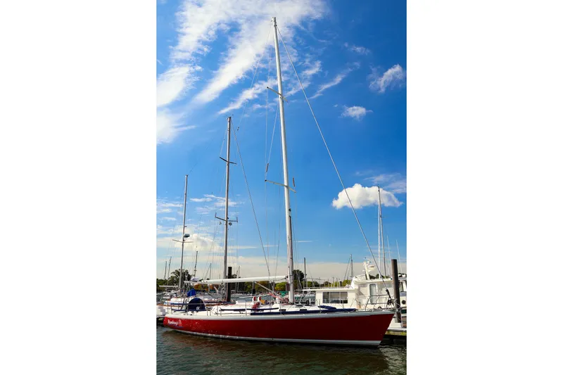 Slide: The Image of 2002 J Boats J/46 sailboat docked under a clear blue sky. - 7