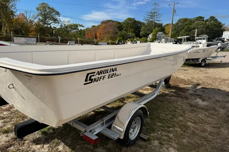 The Image of 2025 Carolina Skiff E21 DLX Kit boat on trailer, outdoor display. - 0