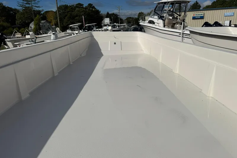 Slide: The Image of 2025 Carolina Skiff E21 DLX Kit boat interior, spacious and clean deck view. - 14