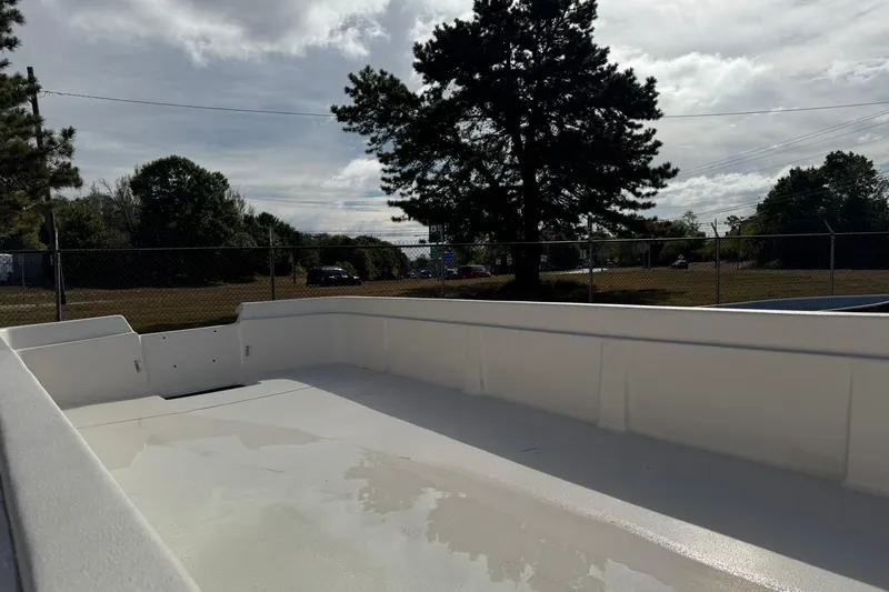 Slide: The Image of 2025 Carolina Skiff E21 DLX Kit boat interior under cloudy sky. - 17