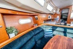Slide: The Image of 2003 Hunter 356 yacht interior with wooden finish, plush seating, and modern amenities. - 11