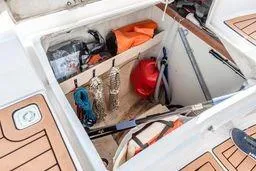 Slide: The Image of Storage compartment on a 2003 Hunter 356 sailboat with various boating equipment. - 14