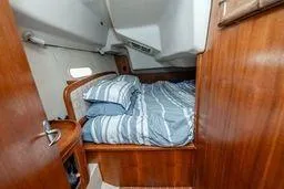 Slide: The Image of Cozy cabin interior of 2003 Hunter 356 sailboat with striped bedding. - 16
