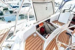 Slide: The Image of 2003 Hunter 356 yacht interior with open hatch and wooden deck. - 19