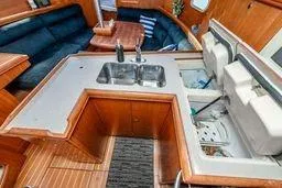 Slide: The Image of 2003 Hunter 356 yacht interior with kitchen sink and seating area. - 20